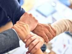 team members gripping wrists in unity gesture