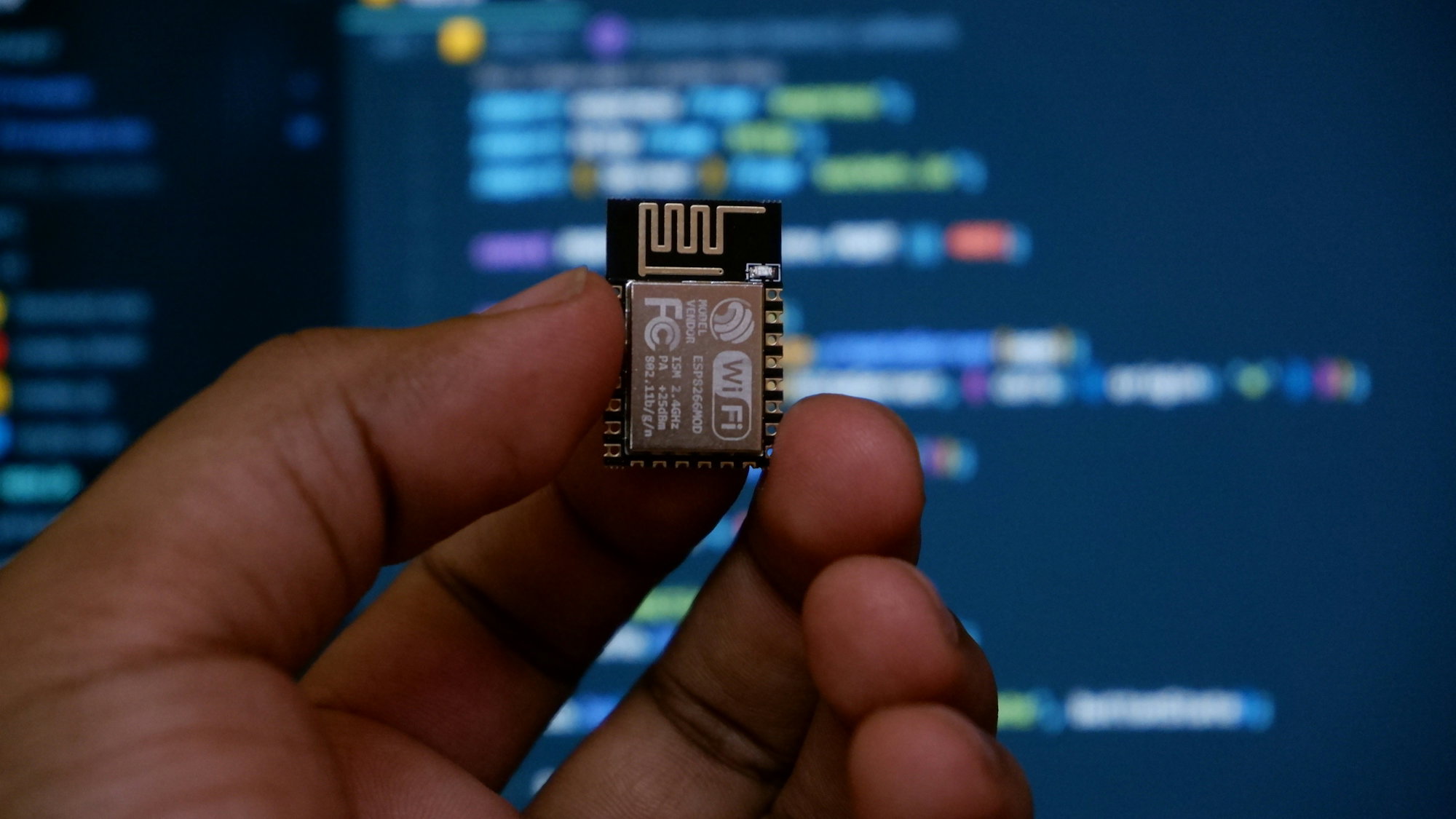 a-hand-holding-a-micro-processor-chip-in-front-of-a-computer-screen.jpg a hand holding a micro processor chip in front of a computer screen